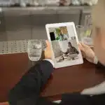 Man Using Tablet Videocall While Drinking Water