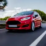 Red Mini Coupe Driving Highway With High Speed
